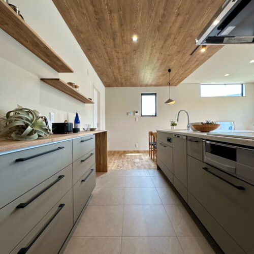 キッチンはタカラスタンダードのオフェリア。  色味は、マットな質感のグレージュを選ばれました。  天井、飾り棚と木目をプラスして温かみのある空間に。