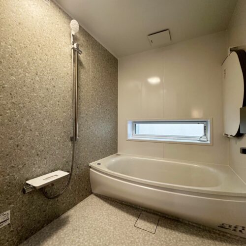 ストーン調のパネルで高級感あるお風呂空間。  浴槽につかったときの目線の高さには、外の様子が見える窓もあるのです◎